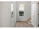 Bright entryway features wood-look floors, white walls, and a window with a view of the yard at 811 Fargo St, Durham, NC 27707