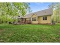Beautiful backyard featuring a well-maintained lawn and a screened-in porch at 85 Rivers Edge Ct, Timberlake, NC 27583