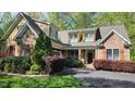 Charming home with stone and siding and manicured landscaping at 85 Rivers Edge Ct, Timberlake, NC 27583