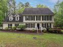 Classic two-story home with black shutters and white trim on a well-manicured lawn at 8805 Stage Ford Rd, Raleigh, NC 27615