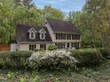 Traditional two-story home with black shutters and white trim, surrounded by flowering shrubbery at 8805 Stage Ford Rd, Raleigh, NC 27615