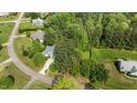 A high angle view of the residence surrounded by mature trees highlighting the landscape and location at 9016 New Century Rd, Wake Forest, NC 27587