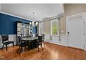 Elegant dining room featuring hardwood floors, a chandelier, and a display case adding a touch of sophistication at 9016 New Century Rd, Wake Forest, NC 27587