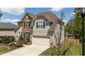Lovely two-story home with stone and vinyl siding, two-car garage, and well-maintained landscaping at 9212 Linslade Way, Wake Forest, NC 27587