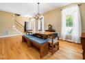 Bright dining area featuring wood floors, chandelier, staircase and natural light at 936 Elbridge Dr, Raleigh, NC 27603
