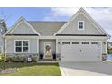 Charming home featuring stone accents, a two-car garage, and a welcoming entrance at 98 Buddy Campbell Ct, Angier, NC 27501