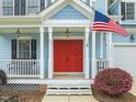 Inviting entryway features a bright red double door and classic architectural details at 101 Rustic Pine Ct, Apex, NC 27502