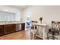 Open-concept kitchen with stainless steel dishwasher and adjacent breakfast bar with seating at 1016 Mirbeck Ln, Durham, NC 27713