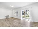 Bright, open-concept living room with hardwood floors, neutral walls, and sliding glass door to the backyard at 1215 Corkery Ridge Ct, Cary, NC 27519