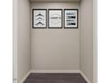 A narrow hallway with three framed Laundry Co. themed wall art pieces and dark laminate flooring at 123 Landon Pl, Roxboro, NC 27573