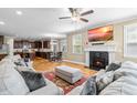 Comfortable living room with a fireplace, large screen television and hardwood floors throughout at 12308 Bunchgrass Ln, Raleigh, NC 27614