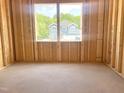 View from inside the new construction home looking out of the window at a neighboring blue house at 139 Fast Pitch Ln, Four Oaks, NC 27524
