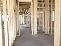 Interior view of the new home construction, highlighting wooden framing and concrete flooring at 139 Fast Pitch Ln, Four Oaks, NC 27524