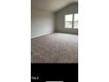 Bedroom with plush carpeting and two windows offering plentiful light at 148 Landon Pl, Roxboro, NC 27573