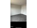Neutral toned bedroom with modern gray-tone floors and a convenient closet at 148 Landon Pl, Roxboro, NC 27573