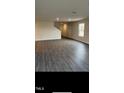 Spacious living room with hardwood flooring, recessed lighting, and a view of the staircase and hallway at 158 Lillian Ct, Roxboro, NC 27573