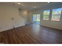 Bright living room with hardwood floors, a sliding glass door, and large windows at 168 Parker Ln, Mebane, NC 27302