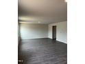 Spacious living room with dark wood floors, neutral walls, and recessed lighting at 173 Lillian Ct, Roxboro, NC 27573