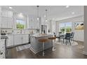 Bright, airy kitchen featuring a center island, modern appliances, and a breakfast nook at 241 Connelly Way, Zebulon, NC 27597