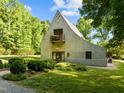 View of home with tall gables surrounded by green lawn and trees at 2509 Nc 57, Hillsborough, NC 27278