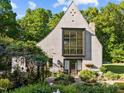 Stunning home features a large front window and lush landscaping with flowering vines at 2509 Nc 57, Hillsborough, NC 27278