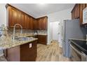 Traditional kitchen featuring wooden cabinets, granite countertops, stainless steel appliances, and tile backsplash at 2808 Polesdon Ct, Raleigh, NC 27615