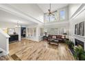Bright living room with high ceilings, large windows, and hardwood floors, with a glimpse into dining area at 2808 Polesdon Ct, Raleigh, NC 27615