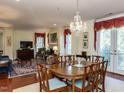Elegant dining room with a chandelier, fireplace, and views through french doors to a balcony at 2813 Market Bridge Ln # 204, Raleigh, NC 27608