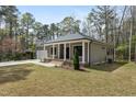 Inviting single-story home featuring a covered front porch and tidy lawn at 3011 Bourbon St, Sanford, NC 27332