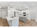 Bright kitchen featuring an island, stainless appliances, and modern pendant lights at 3011 Bourbon St, Sanford, NC 27332