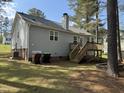 Backyard with wooden deck, green space, and mature trees at 308 Caroline Dr, Wendell, NC 27591