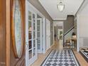 Foyer boasts checkered tile, wood floors, and charming accents, leading to various rooms at 308 Sunset Creek Cir, Chapel Hill, NC 27516
