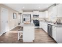 Well-lit kitchen equipped with stainless steel appliances, white cabinets, and granite countertops at 35 Boots Ridge Way, Franklinton, NC 27525