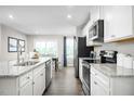 Bright kitchen with white cabinets, stainless steel appliances, and granite countertops at 35 Boots Ridge Way, Franklinton, NC 27525