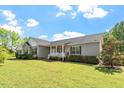 Inviting home featuring a covered porch, manicured landscaping, and a well-maintained lawn at 3604 Stagecoach Rd, Durham, NC 27713