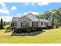 Beautiful home with lush lawn, manicured landscaping, and charming curb appeal at 3604 Stagecoach Rd, Durham, NC 27713