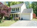 Charming two-story home with a front porch, attached garage, and well-maintained landscaping at 3819 Valleydale Dr, Durham, NC 27703