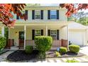 Inviting home with a covered front porch, manicured shrubs, and an ADT security sign at 3819 Valleydale Dr, Durham, NC 27703