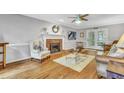 Cozy living room features a fireplace, hardwood floors, and access to the outdoors at 4 W Bridlewood Trl, Durham, NC 27713