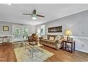 Relaxing living room boasts hardwood floors, comfortable seating, and backyard access at 4 W Bridlewood Trl, Durham, NC 27713