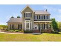 Charming two-story home featuring an inviting front porch and bay window at 4112 Riverport Rd, Raleigh, NC 27616