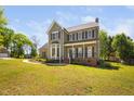 Charming two-story home featuring an inviting front porch and bay window at 4112 Riverport Rd, Raleigh, NC 27616