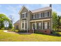 Charming two-story home featuring an inviting front porch and bay window at 4112 Riverport Rd, Raleigh, NC 27616