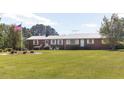 Well-maintained brick ranch with expansive front lawn and mature trees at 481 Firetower Rd, Louisburg, NC 27549