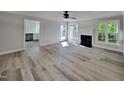 Bright and airy living room with fireplace, ceiling fan, and door to outside deck at 4828 Forest Highland Dr, Raleigh, NC 27604