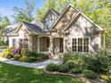 Beautiful home featuring a stone and siding facade, complemented by lush landscaping and a welcoming front entrance at 4924 Theys Rd, Raleigh, NC 27606
