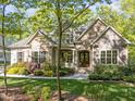 Beautiful home with a stone and siding exterior, complemented by lush landscaping and a welcoming front entrance at 4924 Theys Rd, Raleigh, NC 27606