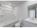 Pristine white bathroom featuring a shower-tub combo, offering a clean and modern aesthetic at 51 Landon Pl, Roxboro, NC 27573