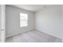 Well-lit bedroom with plush carpeting and a window offering natural light at 51 Landon Pl, Roxboro, NC 27573