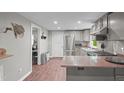 Kitchen view showcases stainless steel appliances, granite countertops, and an eat-in kitchen at 6121 Kelvin Dr, Durham, NC 27712